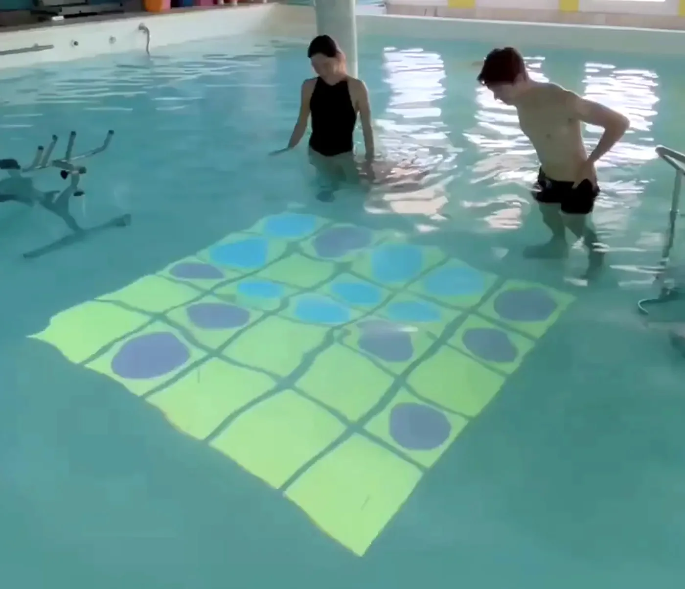 An aquabike class over a projected workout grid