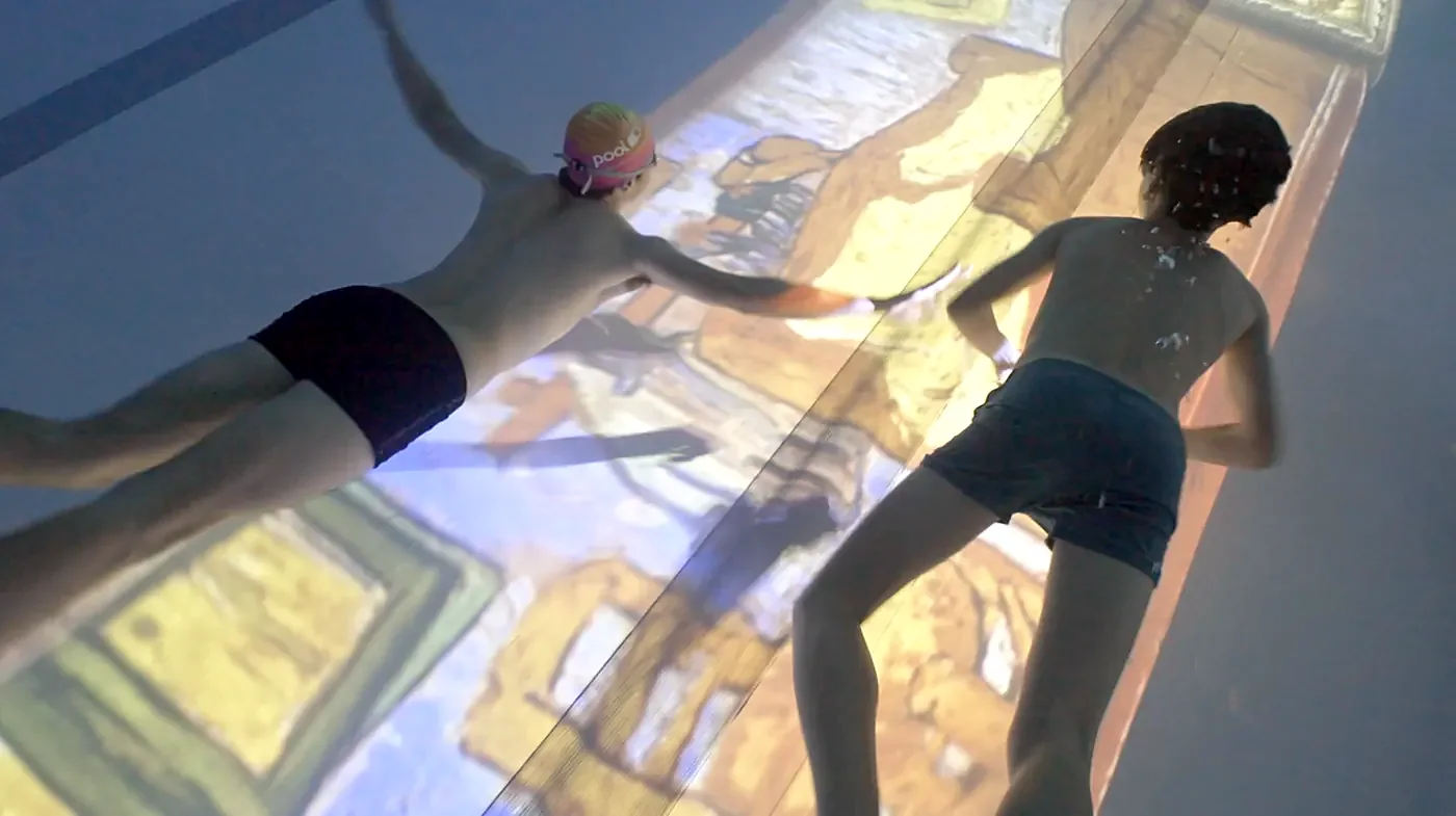Children swimming over a projected Van Gogh artwork